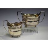A George III silver two-handled sugar bowl of cushion form with engraved anthemion band, on bun