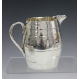 A Victorian silver milk jug of coopered barrel form with reeded horizontal banding, London 1858 by