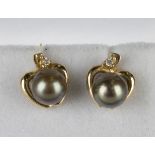 A pair of 18ct gold, sapphire and diamond earstuds, each mounted with a pear shaped sapphire and two