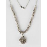 An 18ct white gold and diamond pendant necklace, the pendant of floral and scrolling design, mounted