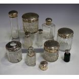 A group of silver topped glass bottles and toilet jars, various dates and makers.Buyer’s Premium