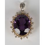 A gold, amethyst and diamond pendant, claw set with a large oval cut amethyst within a two row