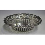 An Art Nouveau silver oval basket with pierced sides and embossed flowers and sinuous stems,