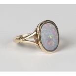 A gold ring, mounted with an oval opal doublet between split shoulders, detailed '9ct', ring size