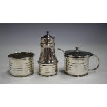 An Art Deco silver three-piece condiment set, comprising salt, pepper and mustard, each with