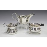 A George V silver two-handled sugar bowl, London 1910, height 7cm, together with two silver sauce