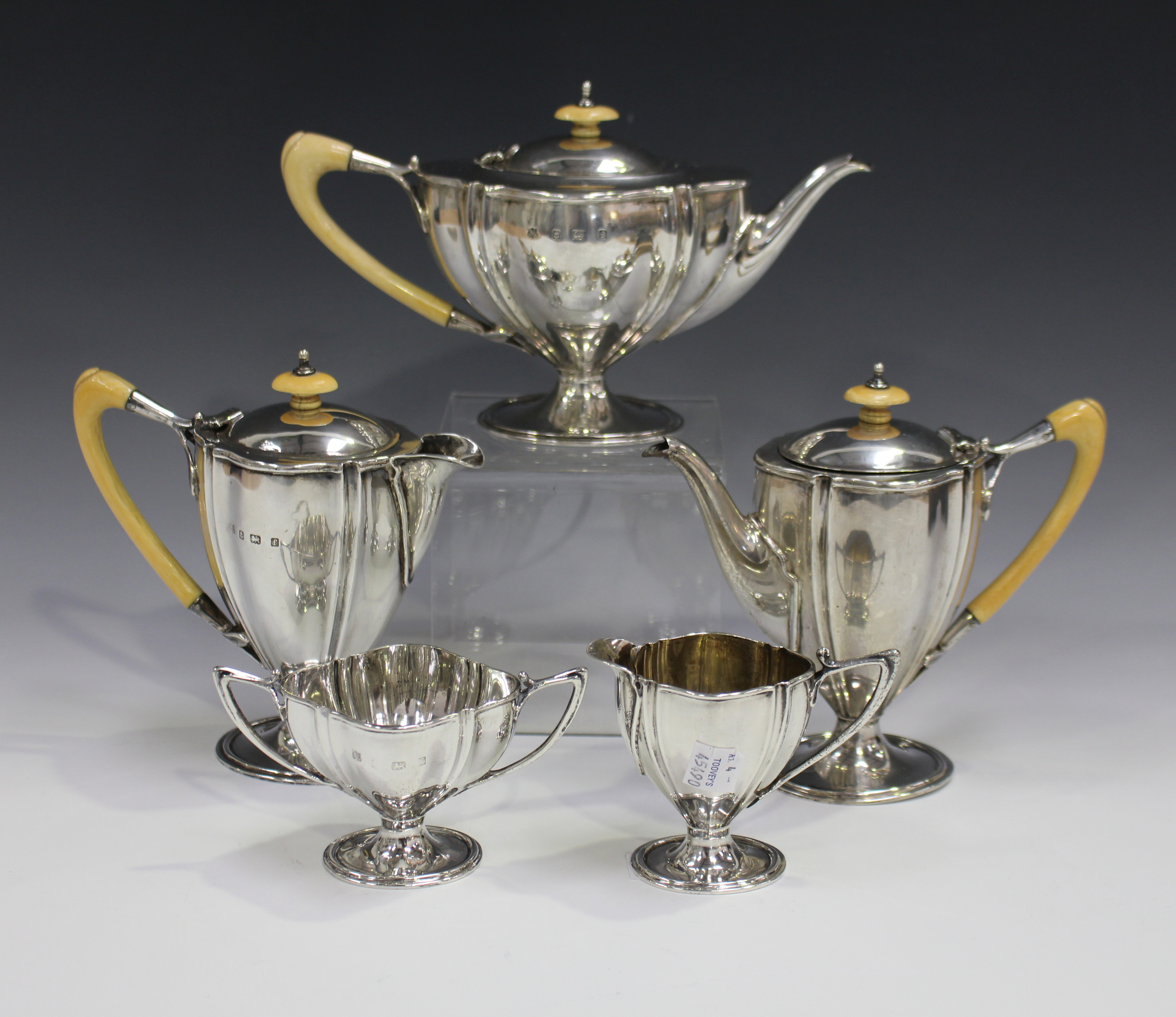 An Edwardian silver four-piece bachelor's tea set, comprising teapot, coffee pot and hot water