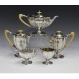 An Edwardian silver four-piece bachelor's tea set, comprising teapot, coffee pot and hot water