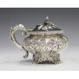 A George IV silver mustard of lobed squat form, repoussé decorated with flower and leaf band, the