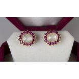 A pair of gold, moonstone and ruby cluster earstuds, each claw set with an oval moonstone within a