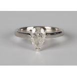 An 18ct white gold and diamond single stone ring, claw set with a pear shaped diamond, ring size