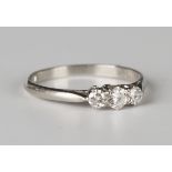 A platinum and diamond three stone ring, mounted with a row of circular cut diamonds, detailed '