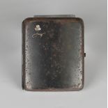 A diamond set iron curved rectangular cigarette case, the front mounted with three principal cushion