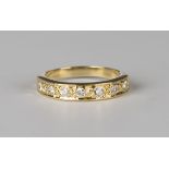 A gold and diamond seven stone half-hoop eternity ring, mounted with a row of circular cut diamonds,