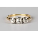 A gold, platinum and diamond three stone ring, claw set with a row of cushion cut diamonds, detailed