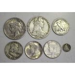 A collection of foreign coins, including a USA one dollar 1934, four half-dollars, comprising