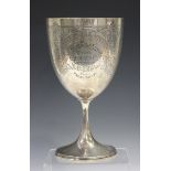 An Edwardian silver trophy cup, the U-shaped body with foliate engraved decoration and