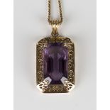 A gold pendant, claw set with a cut cornered rectangular step cut amethyst within a scroll pierced