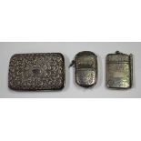 A late Victorian silver vesta case with hinged lid and hinged sovereign compartment, engraved with