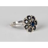 A white gold and sapphire eight stone cluster ring, claw set with the principal circular cut
