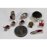 A group of ten novelty silver pin cushions, including a George V circular pin cushion, raised on