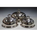 A graduated set of three early 20th century plated oval meat domes by Walker & Hall, each with