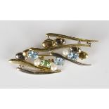 An 18ct two colour gold, aquamarine, peridot and cultured pearl brooch in an abstract design,