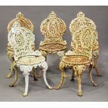 A set of five Victorian white painted cast iron garden chairs with pierced foliate backs and