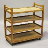 A 20th century oak four-tier trolley with wavy gallery edges, on castors, height 94cm, width 90cm,