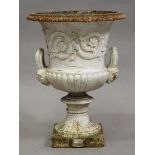 A mid-19th century white painted cast iron garden urn of classical campana form by Andrew