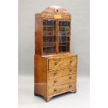 A Regency figured mahogany and satinwood secrétaire bookcase, the arched frieze with lion's mask