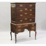 A George I oak chest-on-stand, the moulded pediment above an arrangement of two short and three long