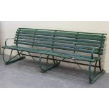 A large early 20th century green painted wrought iron and wooden slatted garden bench, height