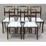 A set of five Regency mahogany and ebonized dining chairs with ropetwist top rails and carved