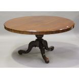 A mid-Victorian mahogany circular tip-top breakfast table, raised on a baluster stem and carved