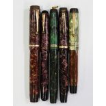 A group of five Parker fountain pens, all with striated and marbled colour casings, including