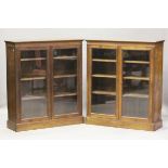 A pair of late Victorian walnut glazed bookcases with fluted sides and adjustable shelves, height