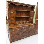 A 20th century reproduction oak dresser, the shelf back above drawers and cupboards, on stile