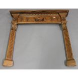 An early 20th century Neoclassical Revival pine fire surround, the frieze carved with central urn,