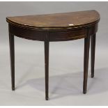 A George III mahogany fold-over demi-lune card table with boxwood stringing, height 72cm, width