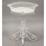 An early 20th century white painted wrought iron and wirework circular plant pot stand, height 90cm,