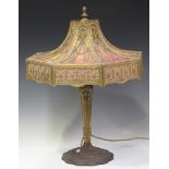 An early 20th century American Neoclassical Revival gilt metal and pink stained glass table lamp,