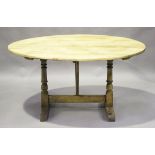 An early 20th century French pine tilt-top vendange or wine tasting table, the oval top on a trestle