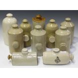 A selection of ten mainly Victorian and Edwardian stoneware hot water bottles and two flagons.