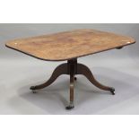 A Regency 'plum pudding' mahogany tip-top breakfast table, the crossbanded top above rosewood banded