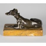 A 19th century brown patinated cast bronze model of a recumbent greyhound, mounted on a Sienna
