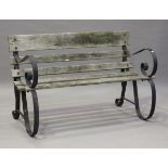A 20th century wrought iron and wooden slatted garden bench, height 77cm, width 120cm.Buyer’s