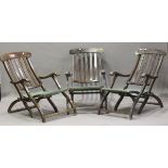 A set of three 20th century hardwood folding garden armchairs with canvas seats, height 85cm,