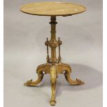 A late Victorian walnut circular wine table, the turned baluster column with three turned