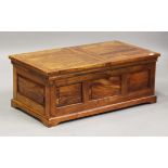 A modern hardwood coffee table trunk, the top fitted with two hinged lids, height 43cm, width 111cm,